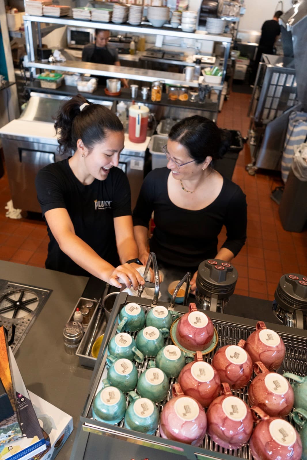 Laughing together at the espresso machine