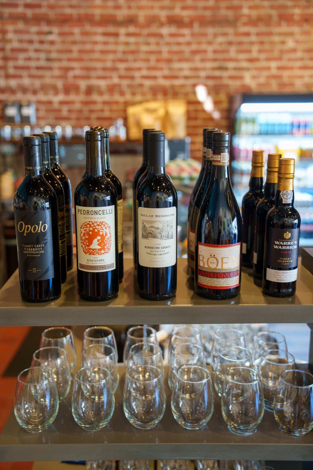 Wine bottles and glasses on the bar shelf