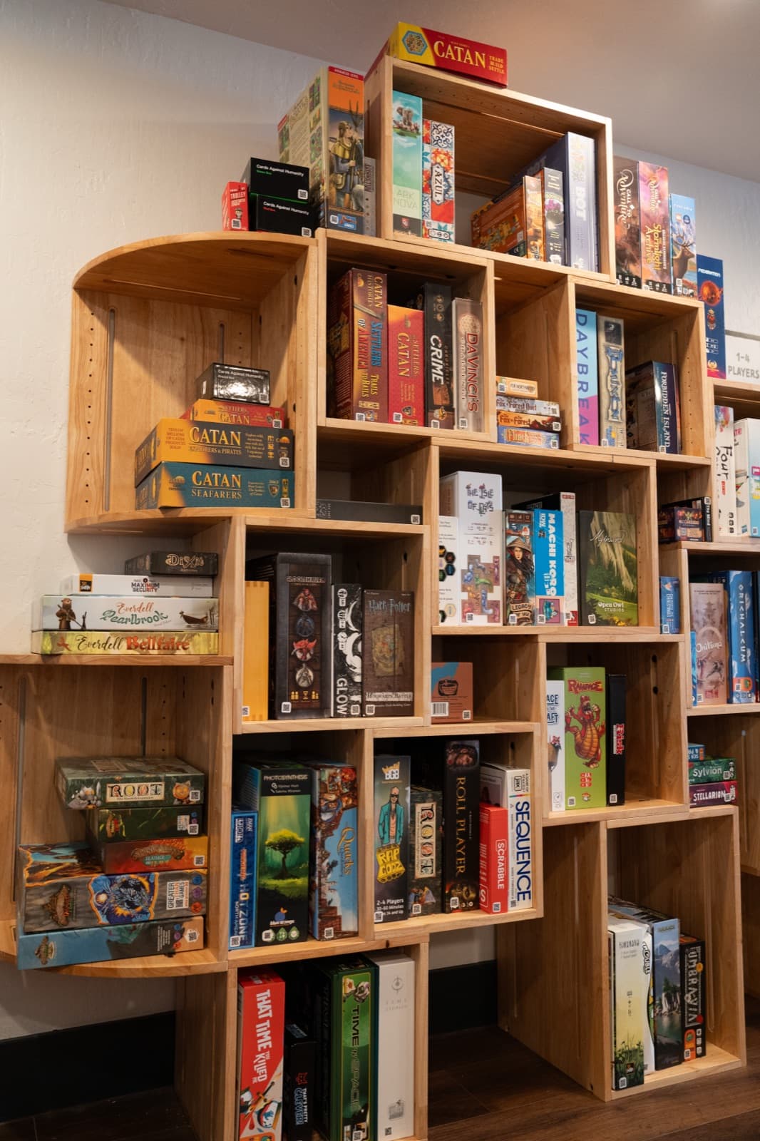 The wall of board games at Plucky’s Cafe